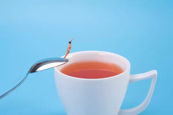 Man jumping into the tea cup