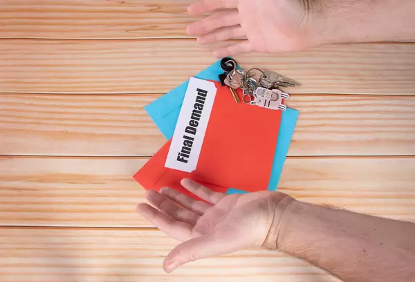 Man opens red envelope with Final Demand text