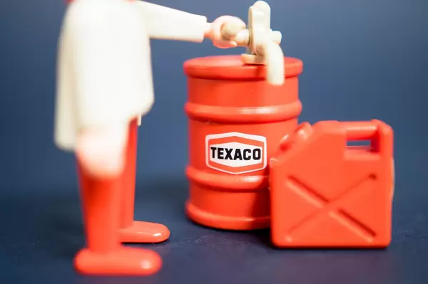 Man pouring gasoline on a container