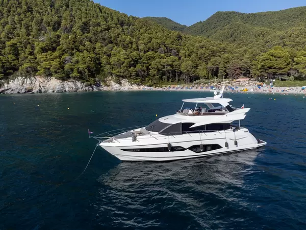 Man relaxing on a yacht in the blue waters of Kastani, Skopelos, Northern Sporades