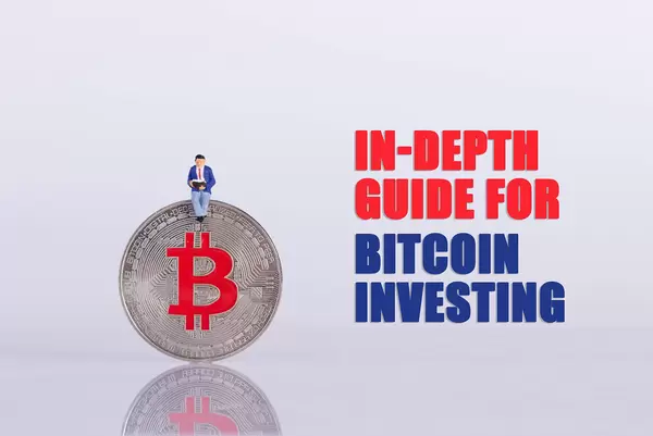 Man sitting on a silver Bitcoin coin with In-Depth Guide for Bitcoin Investing text
