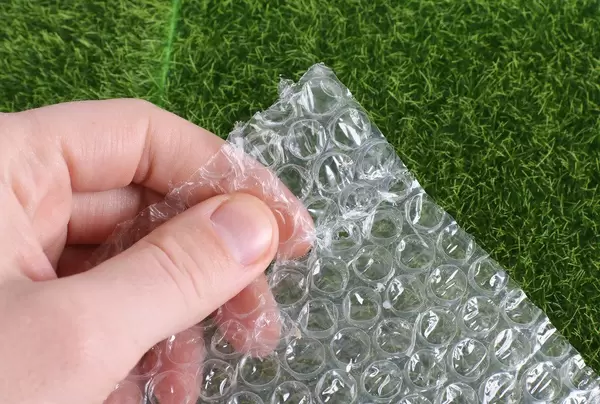 Man squeezing bubble wrap balls