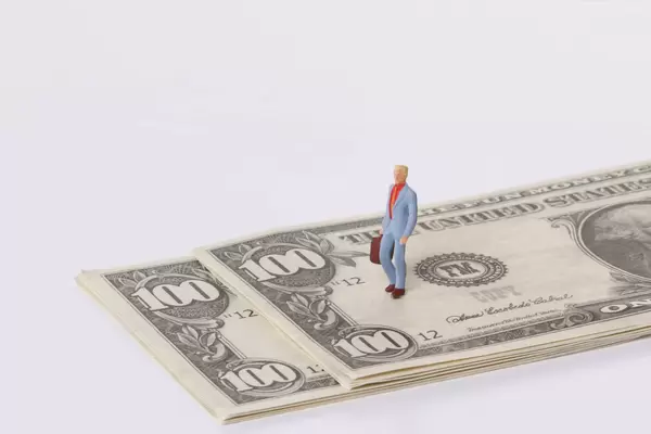 Man stadning on a dollar bank notes