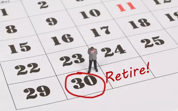 Man standing and looking at marked date with Retire text