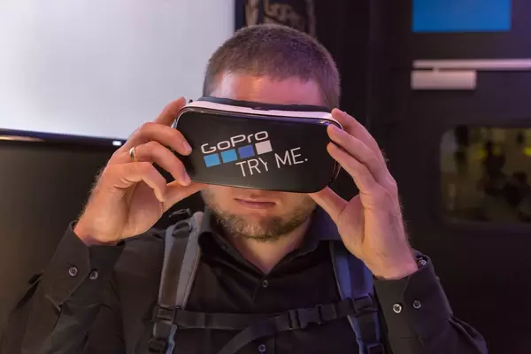 Man tasting the Samsung VR glasses with GoPro Sticker at Photokina Köln