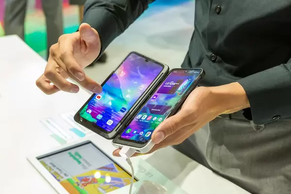 Man tests two screens with the LG G8x ThinQ Smartphone & openable Dual Screen phone case, part of Tom's guide - best of IFA 2019