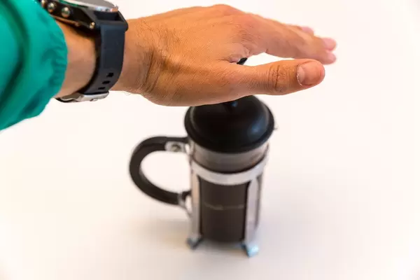 Man using the French Press to make coffee