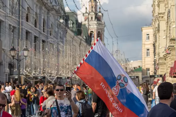 Man waving a Russian flag and recording with his phone