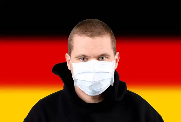Man wearing protection face mask with flag of Germany