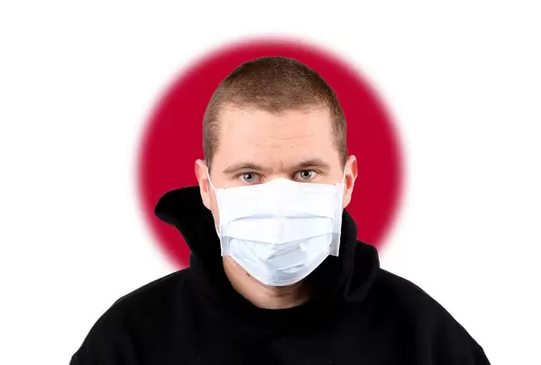 Man wearing protection face mask with flag of Japan