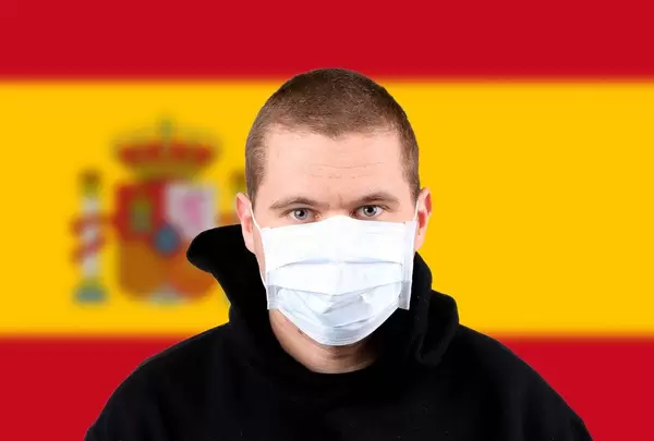 Man wearing protection face mask with flag of Spain