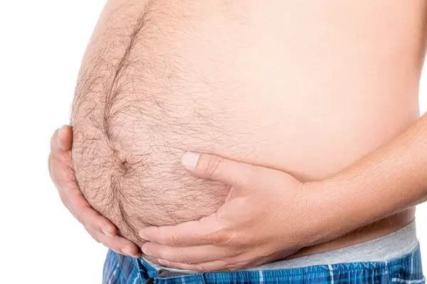 Man with beer belly on white background