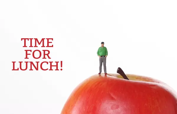 Man with red apple and Time For Lunch text