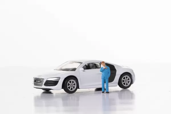 Man with sports car on white background