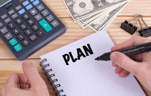 Man writing plans in notebook