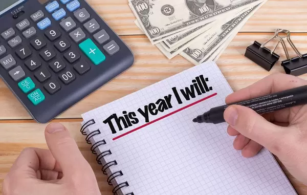 Man writing yearly plans in notebook
