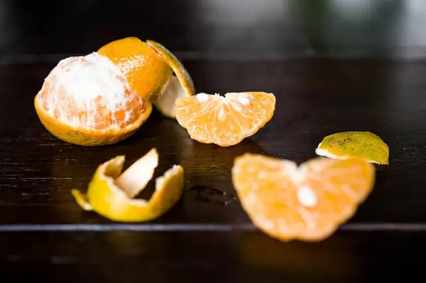 Mandarin orange segments on wooden table