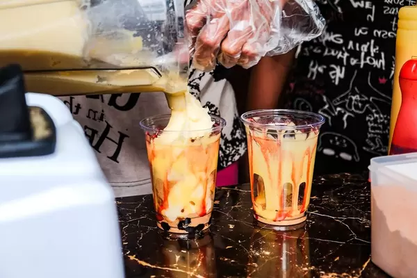 Mango smoothie poured in to a small plastic cup (Flip 2019)