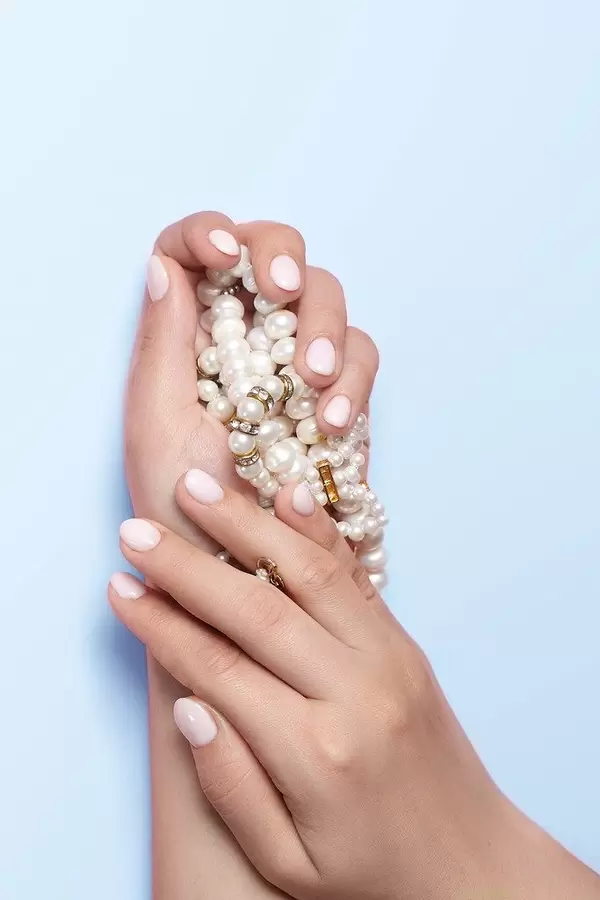 Manicure and beauty concept. Woman showing her beautiful manicure.jpg