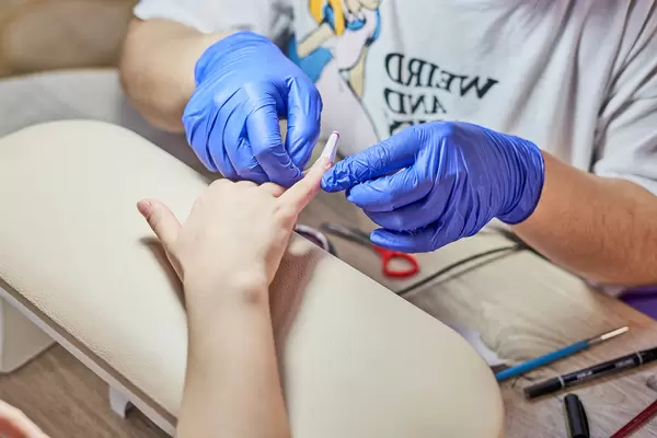 Manicure master making nail extension