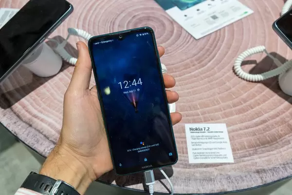 Mann hält das Nokia 7.2 in der Hand und Display zeigt den Ladestatus der Batterie an