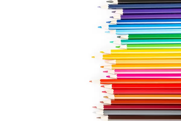 Many different colored pencils on white background