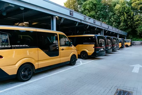 Many electric ride-hailing buses parked at their base station