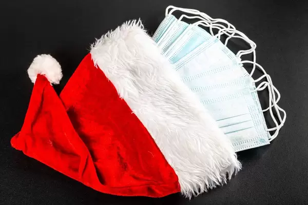 Many medical masks in red santa claus hat