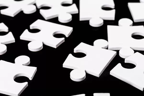 Many pieces from one white mosaic on black background (Flip 2020)