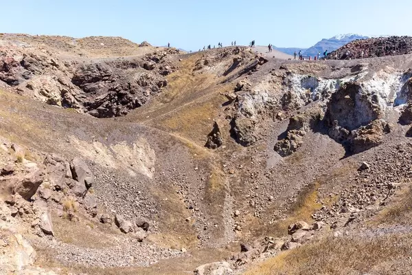Many tourists walk by the crater on the Greek island of Santorini: a must-see landscape