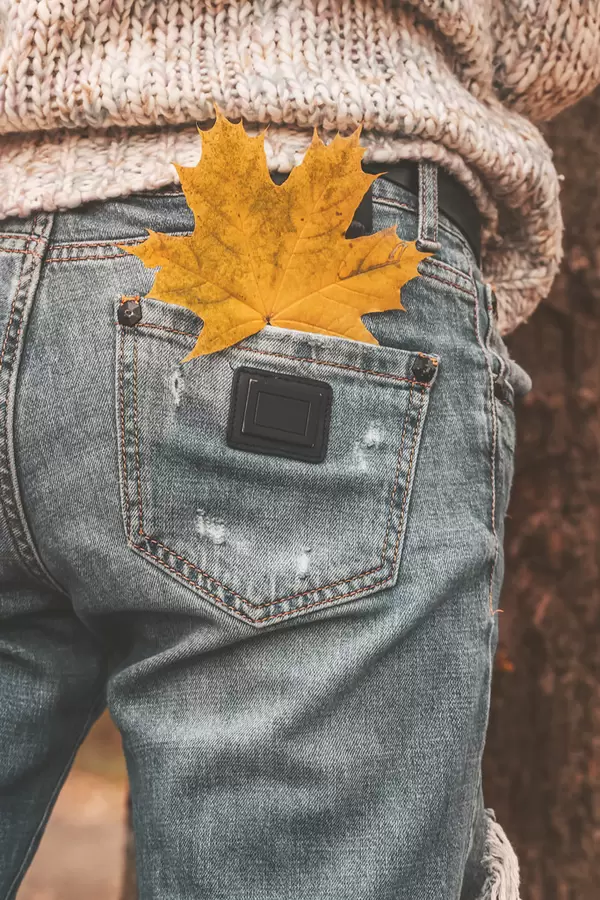 Maple leaf in the pocket of women's jeans