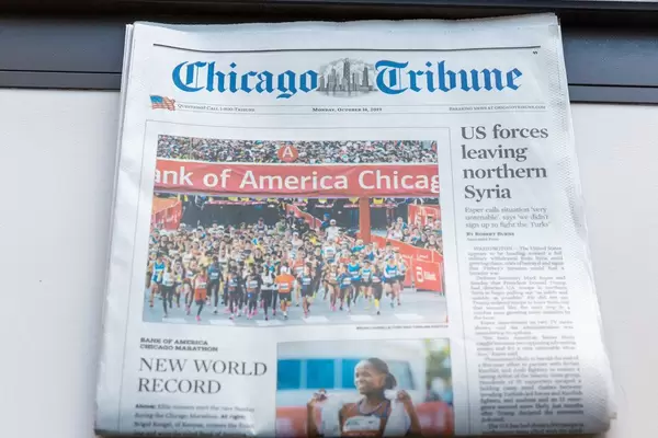 Marathon runners and new world record article on front page of Chicago Tribune Newspaper