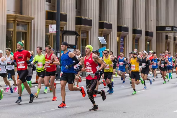 Marathon runners in sports clothes and equipment: athlete with water bottles on his belt