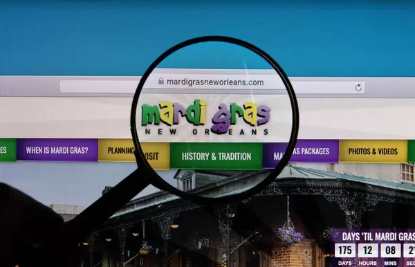 Mardi Gras logo on a computer screen with a magnifying glass