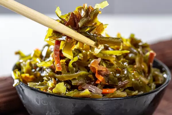 Marinated seaweed close-up with chopsticks