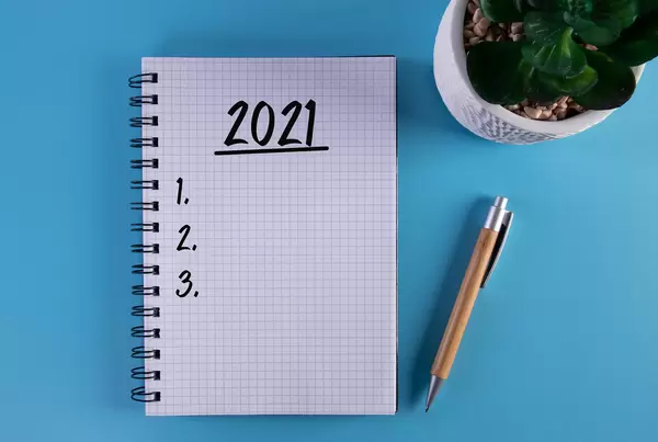 Marker and notebook with 2021 To do list on blue background