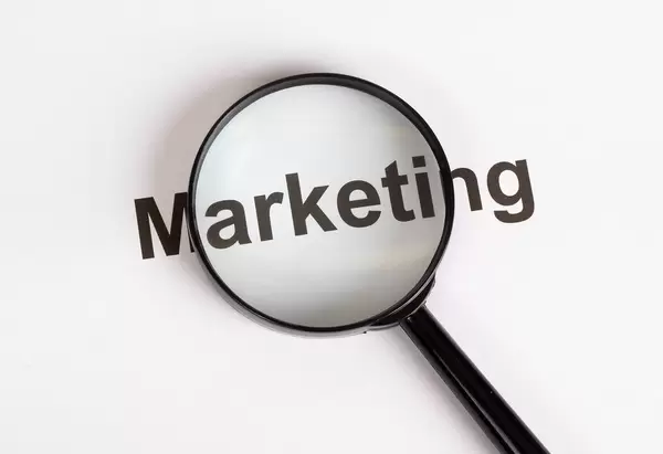 Marketing text under magnifying glass