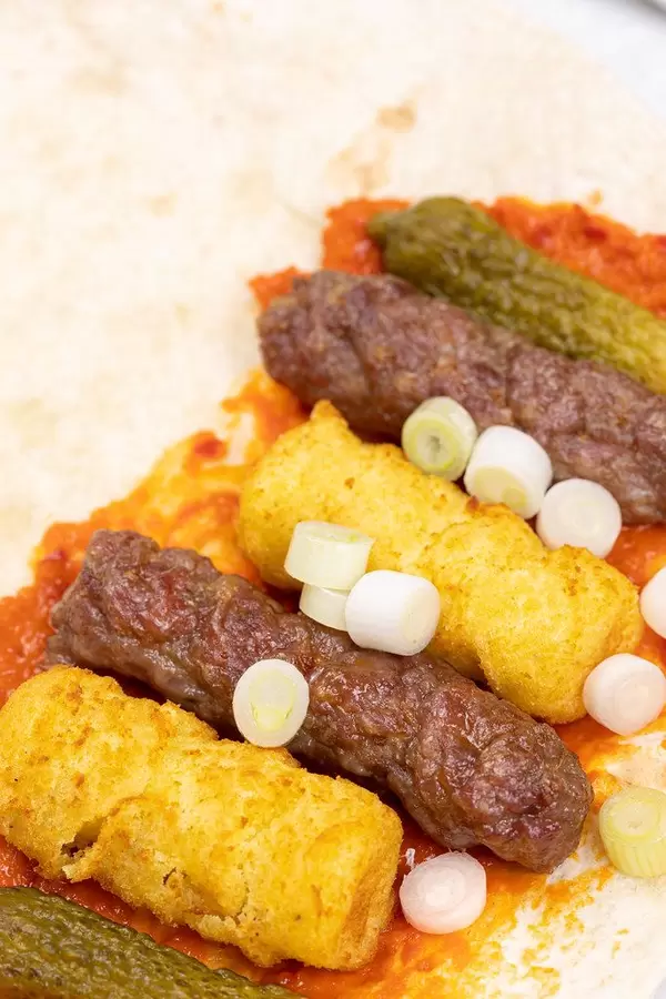 Meal on the table with Kebabs Potatoe Crockets and salad