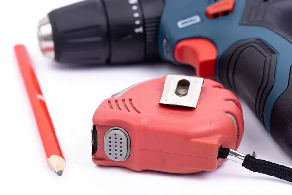 Measuring Tape and Carpenters Pencil by the Drill
