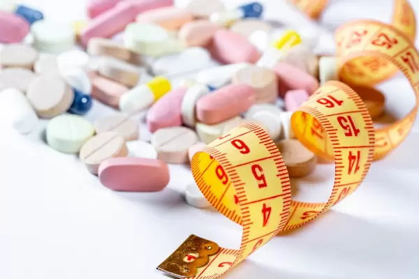 Measuring tape with a bunch of colorful tablets