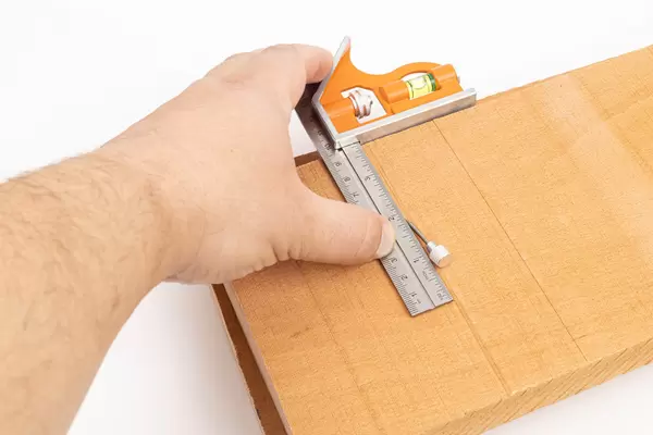 Measuring with Combination Square on the wooden boards