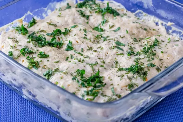 Meat casserole in spicy yogurt sauce on blue background