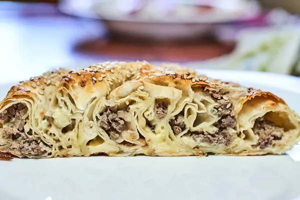 Meat pie cut on the white plate