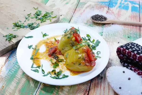 Meat stuffed bell peppers, Greek style. Wooden vintage background (Flip 2019)