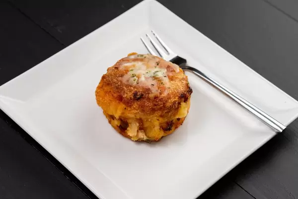 Meatball with melting cheese on the white plate