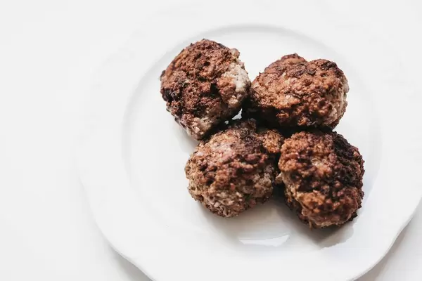 Meatballs in white plate. White background.