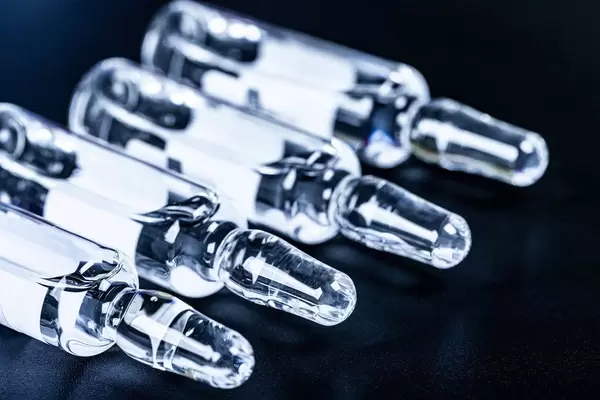 Medical ampoules with medicine on black background (Flip 2020)