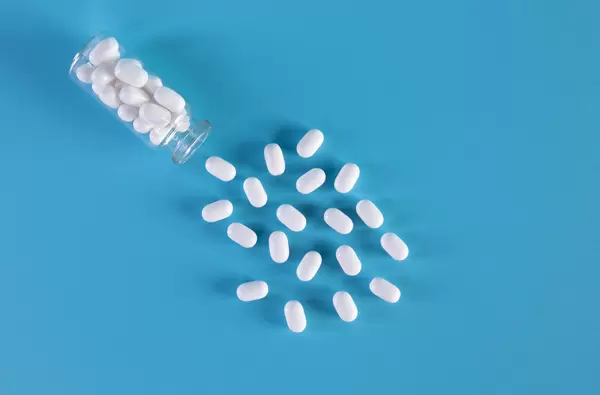 Medical pills on blue background