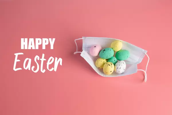 Medical protective face mask and colorful easter eggs with Happy Easter text