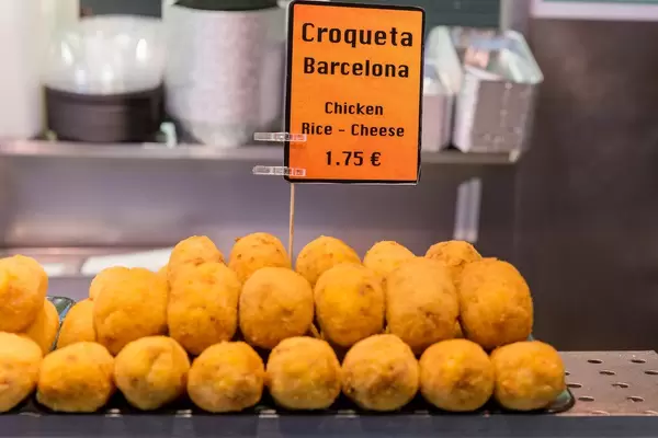 Mediterranes Essen: spanische Kroketten mit Hühnchen, Reis und Käse, als Fertiggericht in der Markthalle Mercat de la Boqueria in Barcelona